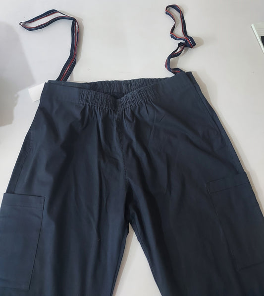 In this photo, the trouser is laid flat on a white surface. one can see two patch pockets on the thigh area on both the sides. elastic on the back and front. there are two loops to help the wearer pull up the trousers and also the caregiver can use the same to help the wearer.